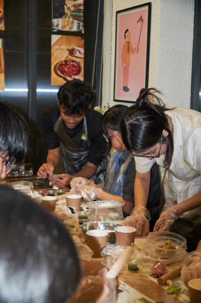 Hands folding mandu at a BONBU mandu making class